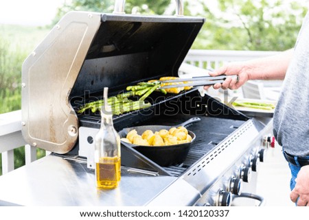 Grilling organic fresh vegetables on an outdoor gas grill in the Summer.