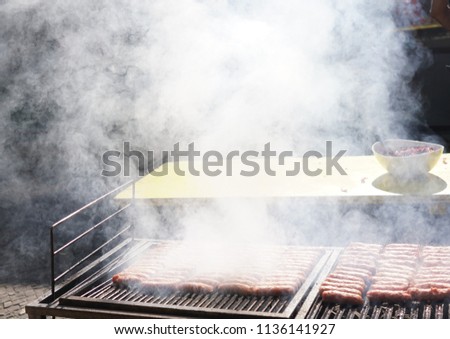 Grilling sausages on a barbecue