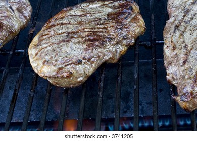 Grilling Steaks On The Grill Nice Cuts Of Meat Close Up Shot Shallow DOF