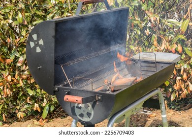 Grillparty is started, fire is ignited at grill - Shutterstock ID 2256709403