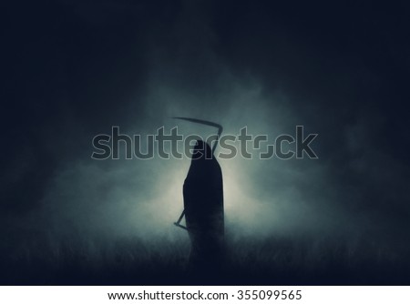 Grim reaper, the death itself, scary horror shot of Grim Reaper in fog holding scythe.