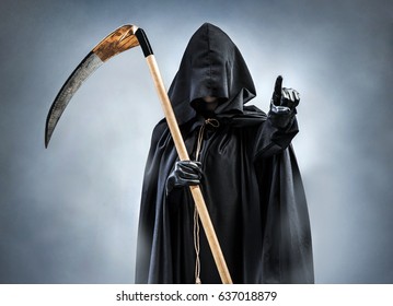 Grim Reaper Points At You. Photo Of Personification Of Death Wielding A Large Scythe In Silhouette.