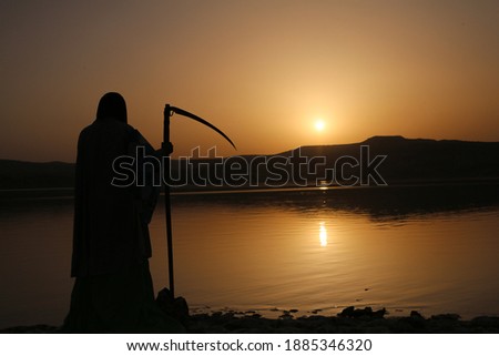 The grim reaper waiting for the sun to set