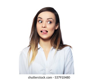 Grimacing Young Woman Making Silly Face Sticking Out Her Tongue On Black Background