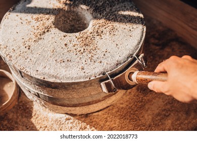 Grind Grain Into Flour Using A Mechanical Stone Mill In The Old Way