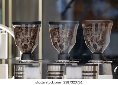 grinder coffee machine. Coffee beans inside the machine hopper of coffee shop. - Powered by Shutterstock