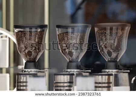 grinder coffee machine. Coffee beans inside the machine hopper of coffee shop.
