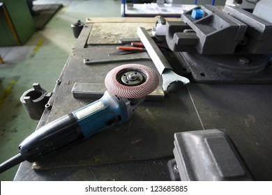 A Grinder And Other Working Tools On A Factory Table