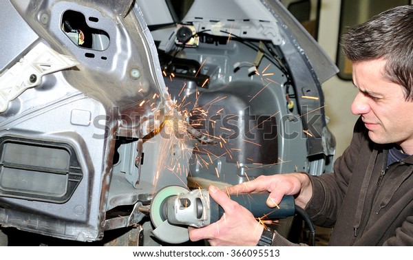 Grinding after welding work\
at a car.