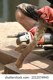 Grinding Machine Being Used To Smooth The Ax Handle.