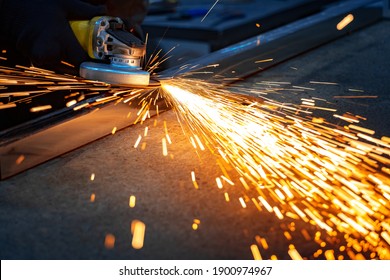 grinding and polishing a metal professional pipe with sparks in the workshop - Powered by Shutterstock