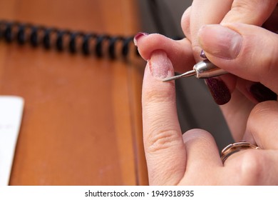 Grinding the skin near the nail of the little finger with a thin cutter head. Independent home hand care. Space for the text. Selective focus. - Shutterstock ID 1949318935