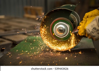 Grinding in a steel manufacturing. Cropped closeup of a metal workpiece being shaped on an electric grinding wheel at metalworking factory  - Powered by Shutterstock