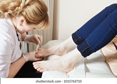 Grinding toenails with file process. Horizontal shot