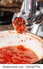 Grinding Tomatoes Through A Meat Grinder.