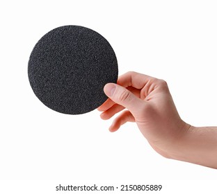 Grinding wheel. Round abrasive paper. Sandpaper disc on a quick-release holder for an angle grinder in a hand on a white background. Sandpaper.Velcro abrasive disc for grinding machine.