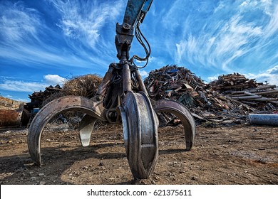Gripper excavator on a scrap yard. HDR - high dynamic range - Shutterstock ID 621375611