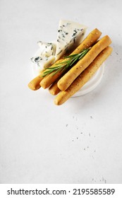 Grissini With Blue Cheese, Bread Stick, Italian Traditional Cuisine Close Up On White Background, Top View, Vertical