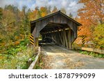 Grist Mill Covered Bridge in Cambridge, Vermont during fall foliage.
