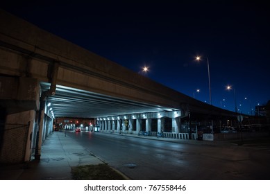 Gritty Dark Chicago Highway Bridge And City Street With A Car And Bicycle Stand At Night.