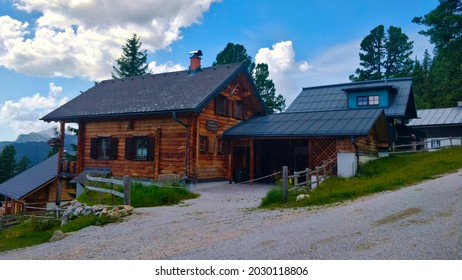 Grobming, Austria - August 15, 2021: Wooden Mountain House In The Village With Garage For Parking Vehicles.