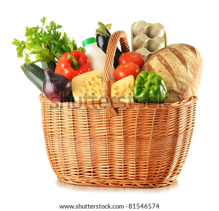 Groceries in large wicker basket isolated on white