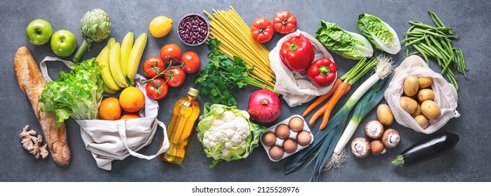 Groceries Shopping. Flat Lay Of Fruits, Vegetables, Greens, Bread And Oil In Eco Friendly Bags, Top View. Healthy Eating And Sustainability Concept