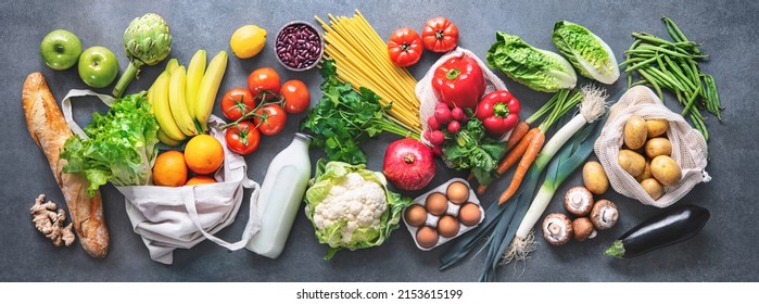 Groceries shopping. Flat lay of fruits, vegetables, greens, bread and oil in eco friendly bags, top view. Healthy eating and sustainability concept - Shutterstock ID 2153615199