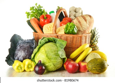 Groceries in wicker basket including vegetables, fruits, bakery and dairy products and wine isolated on white - Shutterstock ID 81980674