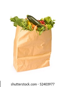 A grocery bag full of healthy vegetables - isolated on white