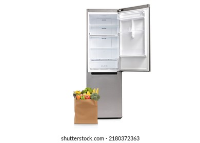 Grocery Bag On The Floor Next To An Open Empty Fridge Isolated On White Background