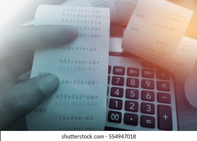 Grocery shopping receipt and calculator on wood table                                - Shutterstock ID 554947018