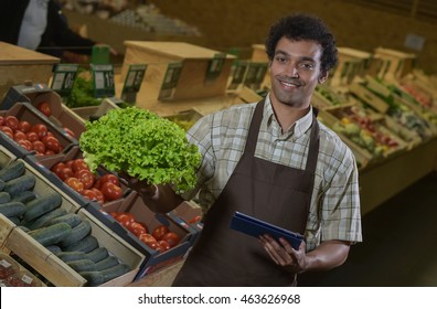 Grocery Store Employee Reading Inventory List On Digital Tablet, France