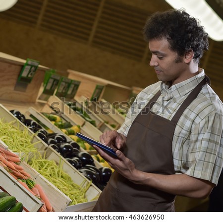 grocery store employee reading inventory list stock photo edit now