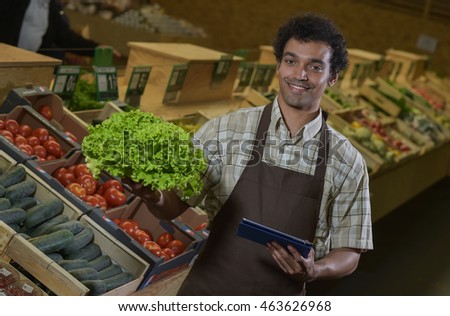 grocery store employee reading inventory list stock photo edit now