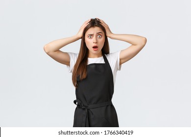 Grocery Store Employees, Small Business And Coffee Shops Concept. Troubled Alarmed Barista Grab Head And Drop Jaw Concerned, Hear Shocking News, React Astonished, Standing White Background