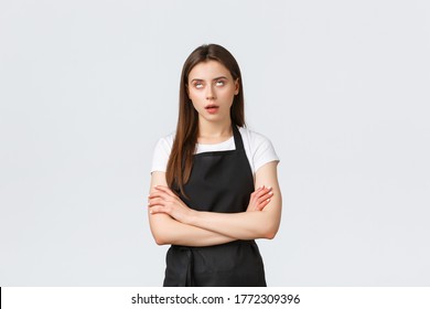 Grocery Store Employees, Small Business And Coffee Shops Concept. Annoyed And Pissed-off Barista Do Eye Roll And Sighing Irritated, Fed Up With Uninteresting Conversation