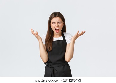 Grocery Store Employees, Small Business And Coffee Shops Concept. Angry Displeased Female Barista Shouting And Complaining At Someone, Raise Hands In Dismay Grimacing Bothered