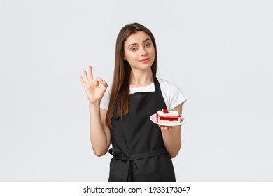 Grocery store employees, small business and coffee shops concept. Cute barista recommend delicious cake, showing okay gesture, guarantee that desserts in cafe delicious, white background - Powered by Shutterstock