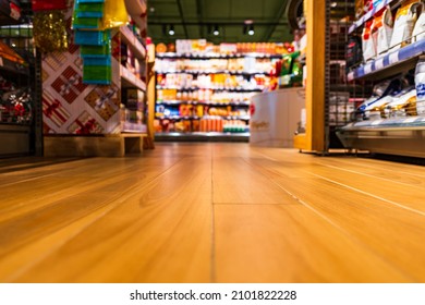 Grocery store. In the mall. Go shopping. Shelves with various goods. Product selection. Daily worries. The era of consumption. Focus on the floor. Close-up view from the level of the floor tiles. - Shutterstock ID 2101822228