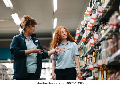 Grocery Store Manager Training New Female Worker. Grocery Store Manager Explaining Work To A New Saleswoman.