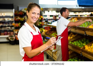 Grocery Store Staff With Clipboard In Grocery Store