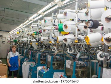 GRODNO, BELARUS - DECEMBER 14, 2014. Woman work in weaving machinery for the production of yarn. High quality photo