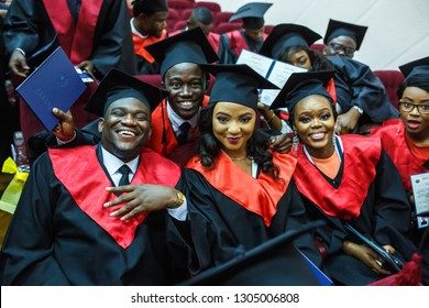 GRODNO, BELARUS - JUNE, 2018: Foreign African Medical Students In Square Academic Graduation Caps And Black Raincoats During Commencement With Diploms