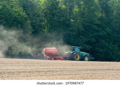 Grodno, Belarus, June 22, 2020: Sowing Equipment Works On The Field On A Dry Summer Day. Season To Sow Cereals. A Farmer Driving A Tractor With A Cultivator.