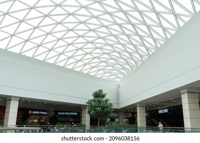 Grodno, Belarus May 20, 2021: Wide And Spacious Lobby On The Top Floor Of The Shopping Center. Beautiful Designer Ceiling Of Geometric Shape And Unusual Perspective In The Mall Center.