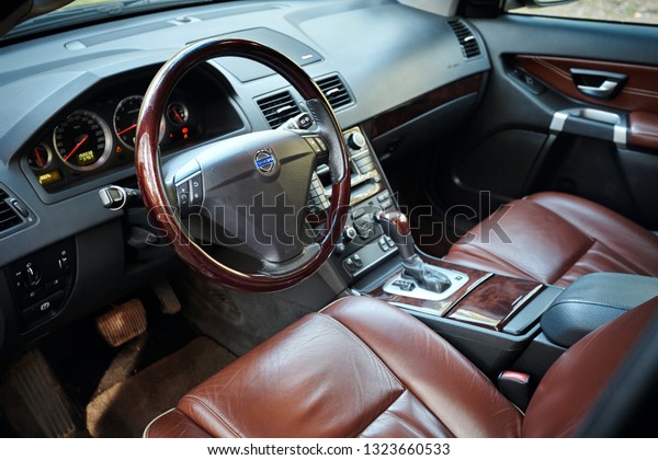GRODNO, BELARUS - MAY 2015: Volvo XC90\
4.4 v8 1st generation restyling 4WD SUV premium car interior brown\
leather with forest view closeup from driver\
side