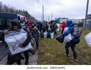 GRODNO, BELARUS - NOVEMBER 19, 2021: Migrants gathered inside a logistics center on the Belarusian side of the border. Belarus, cleared a migrant camp near the border with Poland.