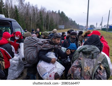 GRODNO, BELARUS - NOVEMBER 19, 2021: Migrants gathered inside a logistics center on the Belarusian side of the border. Belarus, cleared a migrant camp near the border with Poland.
