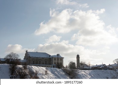 Grodno. Belarus. The Old Part Of The City - A Fire Tower, An Old Synagogue Building, Low Wooden Houses - On High Snow-covered Hills.